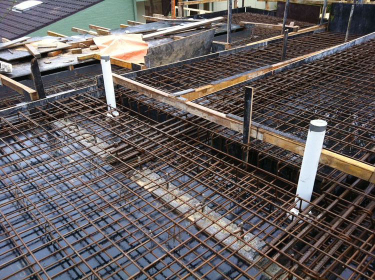 A photo of a suspended slab floor under construction, showing the steel reinforcement ready for concrete to be poured.